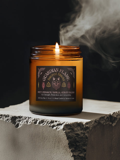 Amber glass jar with Guardian Flame label featuring a metallic wolf and flame motifs in pink and gold. Spicy cinnamon, vanilla, and gurjun balsam candle. 9 oz soy candle by Grimoire & Goblet.